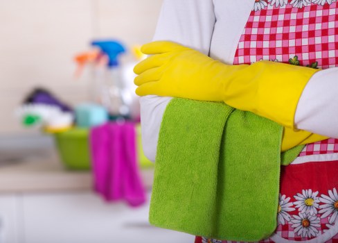Technician wearing PPE during professional carpet cleaning